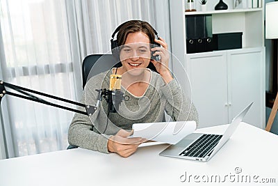 Host channel in broadcaster with script note reading to listeners. Pecuniary. Stock Photo