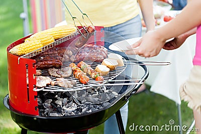 Host serving woman grilled sausage Stock Photo