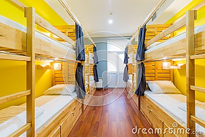 The hostel dormitory beds arranged in room Stock Photo