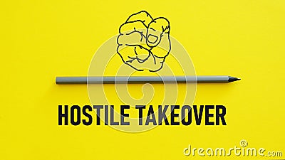 Hostile takeover is shown using the text and picture of the fist Stock Photo