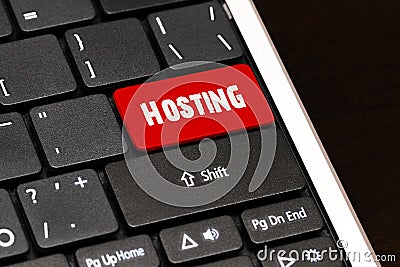 Hosting on Red Enter Button on black keyboard Stock Photo