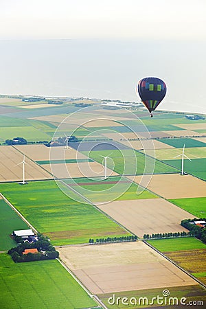 Hot air balloon with agricultural landscape