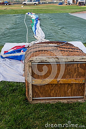 A hot air balloon is being laid on the ground in preparation for blowing up. Stock Photo