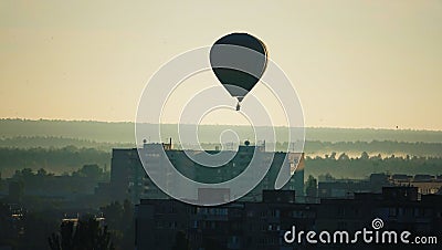 Hot air balloon early in the morning over residential buildings Editorial Stock Photo
