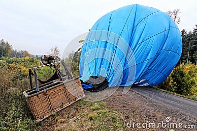 Hot air balloon laid over the road Stock Photo