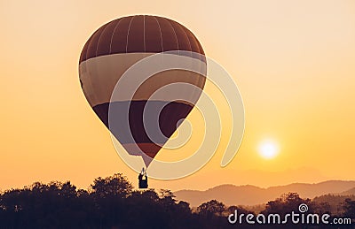 Hot air balloon floating on the sky with beautiful sunset. Conceptual of travel and journey. Stock Photo