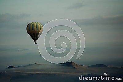 Hot Air Balloon Over Mountains Stock Photo