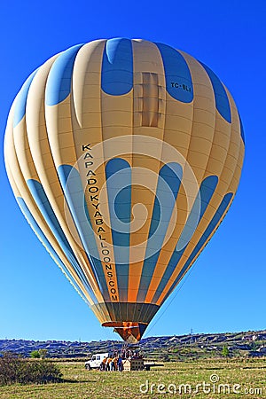 Hot air balloon with tourists landing in Cappadocia Turkey Editorial Stock Photo