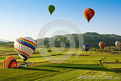 Hot air balloons fly over Cappadocia, Goreme, Cappadocia, Turkey. Stock Photo