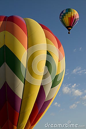 Hot air balloons launching against a blue sky Stock Photo