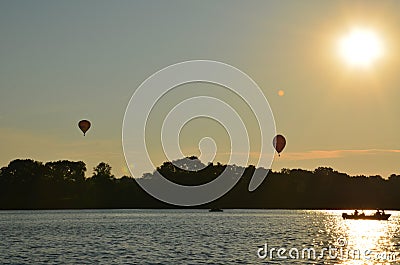 Hot air balloons over a lake in Poland view during sunset Stock Photo