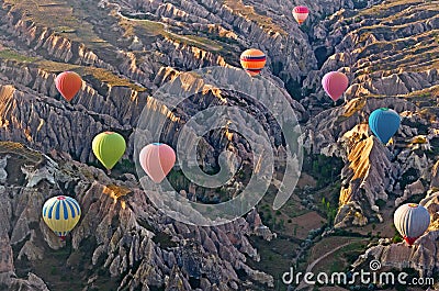 Hot air balloons over mountain landscape in Cappadocia, Turkey Stock Photo