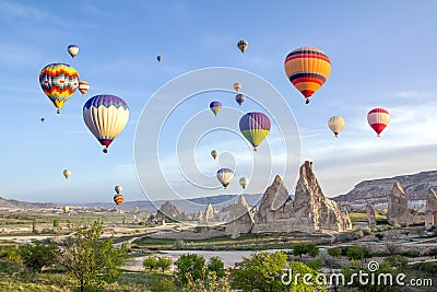 Hot air balloons in the sky over the cave town, Valley of Daggers, Cappadocia, Turkey Stock Photo
