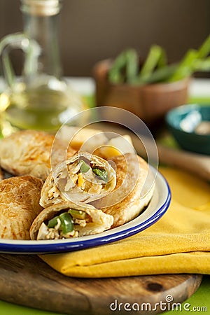 Hot appetizer for family dinner.baked puff pastry pies stuffed with chicken, cheese,pepper on wooden board and green background Stock Photo