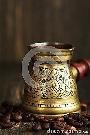 Hot arabica coffee in a brass jezve Stock Photo