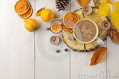 Hot autumn drink, coffee or cocoa, with yellow leaves and decorative pumpkins on a white wooden table. autumn composition. top vie Stock Photo