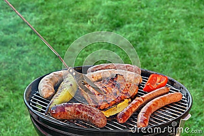 Hot BBQ Grill With Assorted Meat On The Garden Lawn Stock Photo