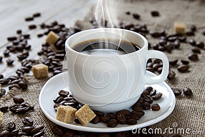 Hot black coffee in a white cup, cane sugar and roasted beans Stock Photo