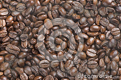 Hot black roasted arabica coffee beans with smoke effect Stock Photo