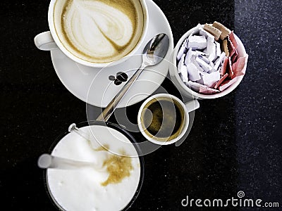 Hot cappuccino, espresso coffee in the white cups, latte on the table Stock Photo