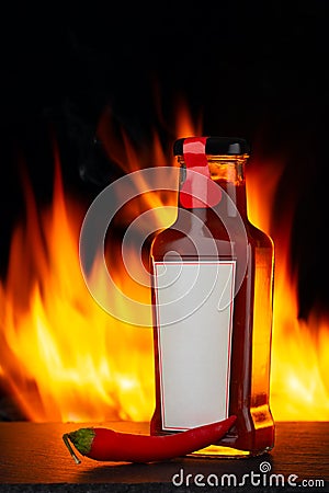 Hot chili pepper sauce and fire Stock Photo