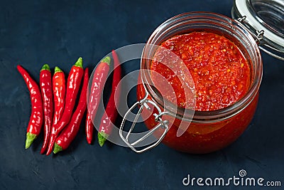 Hot chili pepper sauce paste harissa. Adjika. Traditional Tunisia, Georgian and Arabic cuisine. Homemade rose harissa in a glass Stock Photo