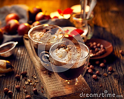 Hot chocolate with whipped cream, sprinkled with aromatic cinnamon in glass cups Stock Photo