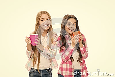 Hot cocoa recipe. Children drink enough during school day. Make sure kids drink enough water. Girls kids hold cups white Stock Photo