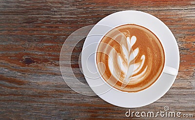 Hot coffee cappuccino latte art top view on wooden background Stock Photo