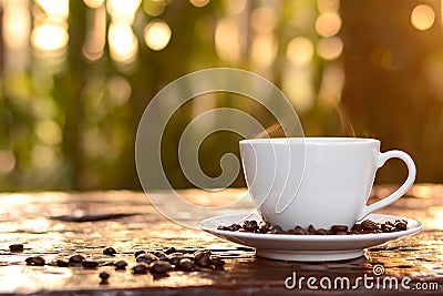 Hot coffee in the cup on blurred dark green nature background Stock Photo