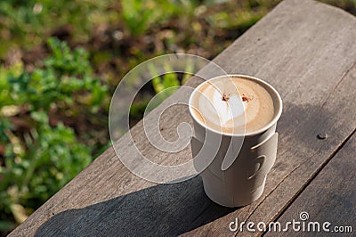 Hot coffee in the morning on wood table with blurred garden in b Stock Photo