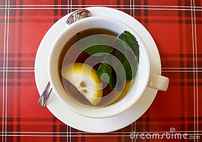 Hot cup of tea whith lemon and mint Stock Photo