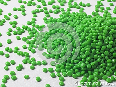 Hot cutting type green masterbatch granules on white background, masterbatch is used as product colorant in plastic industry Stock Photo