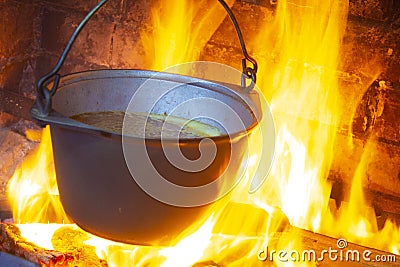 Hot delicious steaming food in a cast iron pot Stock Photo