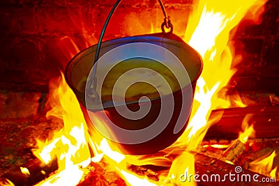 Hot delicious steaming food in a cast iron pot Stock Photo