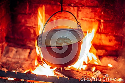 Hot delicious steaming food in a cast iron pot Stock Photo