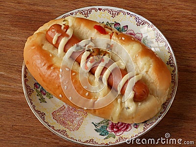 Hot dog bun garnished with cheese and sauerkraut Stock Photo