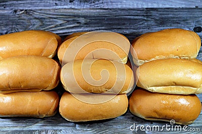 Hot dog bun is a type of soft bun shaped specifically to contain a hot dog or another type of sausage, small side-loading buns for Stock Photo