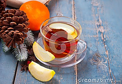 Drink of apple tea with cinnamon stick, star anise and clove. Seasonal punch in cup on wooden background Stock Photo