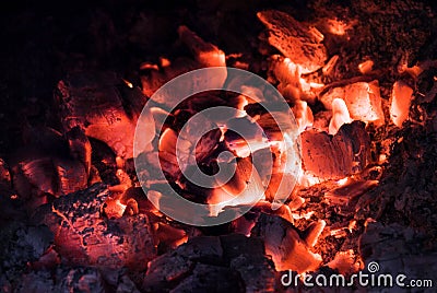 Hot Embers glowing and burning in stove. Close up Stock Photo