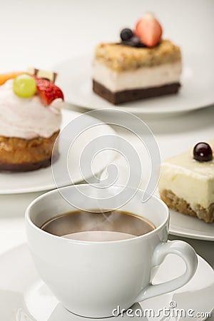 Hot fresh cup of coffee with a variety of cakes Stock Photo