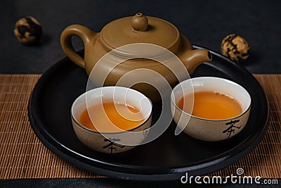 Hot green tea in clay Chinese cups and clay teapot. An old Stock Photo