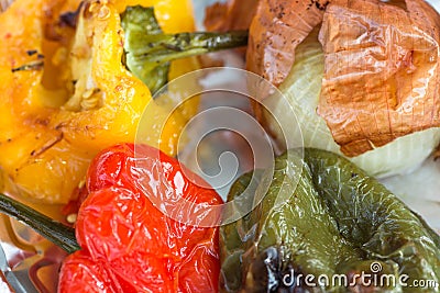 Hot Grilled Seasoned Vegetables Red Yellow Green Capsicums Onions in Tint Foil. Healthy Street Food Urban Culture. City Life Trave Stock Photo