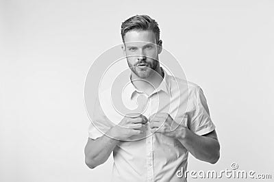 It is hot here. I will show you my sexy body. Man handsome bearded guy undressing yellow background. Guy confident Stock Photo