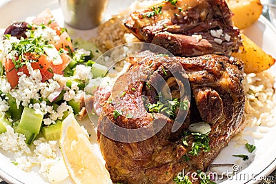 Hot and juicy roasted lamb with greek salad. Authentic Greek food. Stock Photo