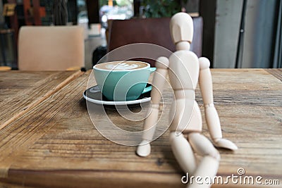 Hot mocha coffee or capuchino in the green cup on the wooden table Stock Photo