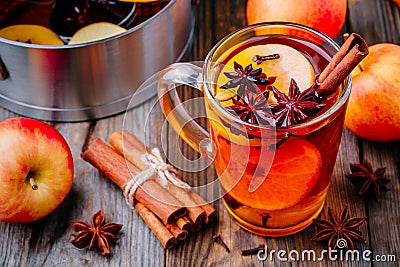 Hot mulled apple cider with cinnamon sticks, cloves and anise Stock Photo