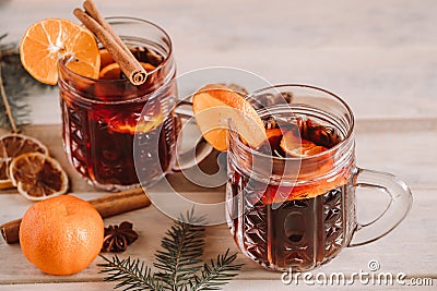 Hot mulled wine with spices in glass cup on wooden background. Christmas warming drink Stock Photo