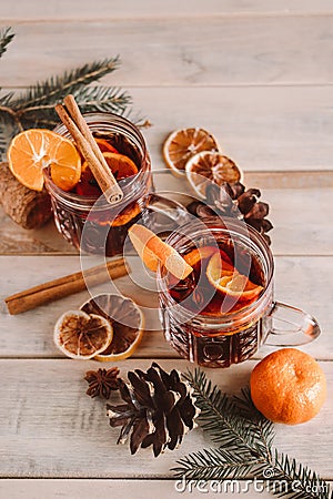 Hot mulled wine with spices in glass cup on wooden background. Christmas warming drink Stock Photo