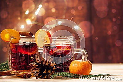 Hot mulled wine with spices in glass cup on wooden background. Traditional Christmas warming drink Stock Photo